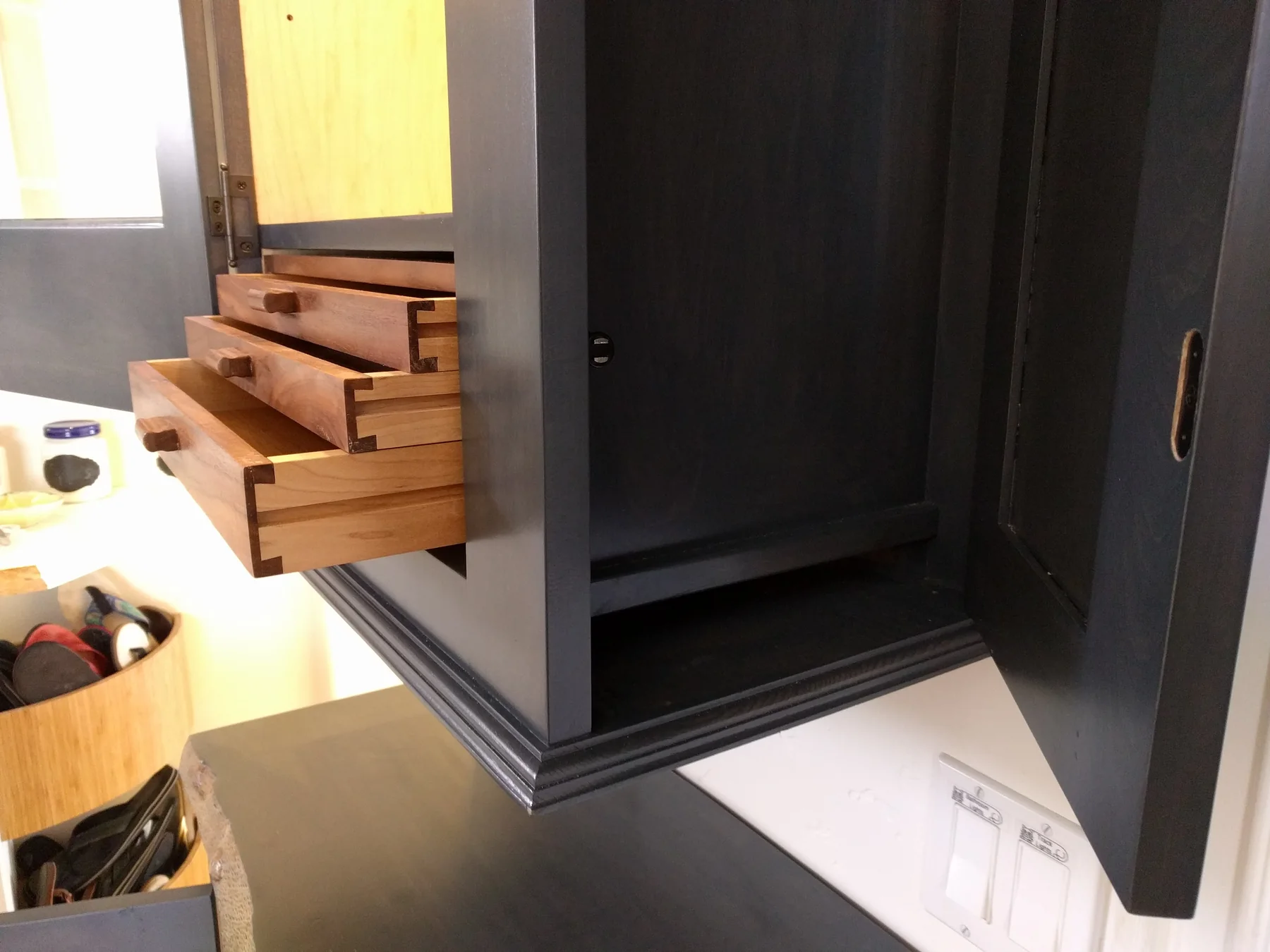 Finished bathroom built-ins with tall painted storage